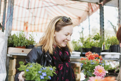 happy-mature-woman-buying-flower-plants-in-nursery-2021-04-05-01-04-49-utc
