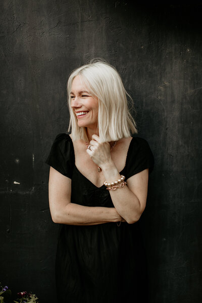 Woman laughing during a candid branding photo session.