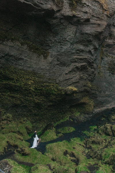 Couple climbs up a path during their Iceland elopement