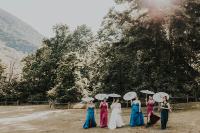 bridal party walking with parasols