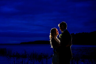 A serene moment captured during blue hour on Lake Champlain, showcasing the couple's love against the tranquil waters