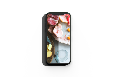 mockup of a smartphon showcasing the preset action on a table with grapefuits and a wood plate and a glass