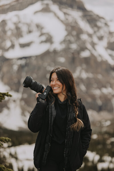 Rocky Mountain Weddings Creative Director inside smiling in The Gem Event Centre Located By Banff and Canmore