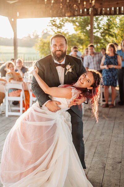 Bride and groom doing first dance in a golden hour time