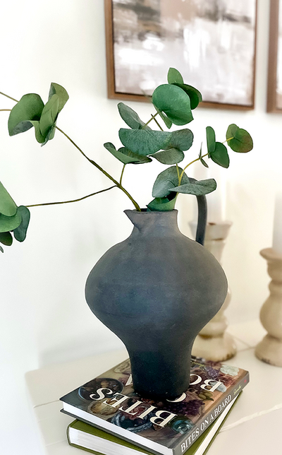 Dark Vase with Greenery (blurred background)