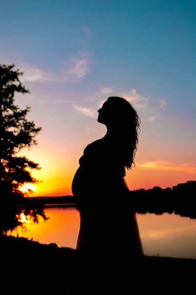 Sunset silhouette photo of pregnant mom in Baton Rouge