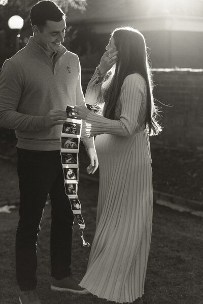 A documentary photo of an expecting couple and their ultrasound photos at the University of VA in Charlottesville