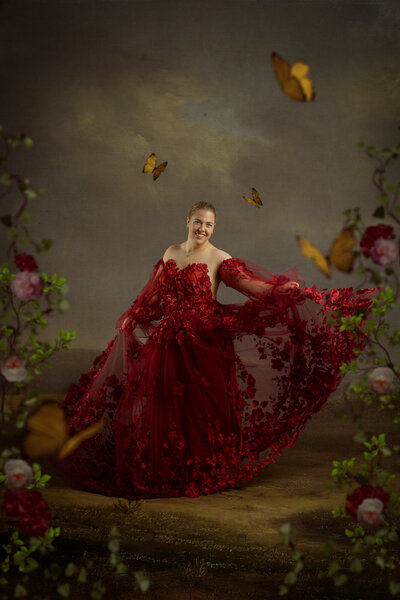 Studio Ace Photography Fine art portret van dame in handgemaakte rode jurk met bloemen in een schilderachtige setting 