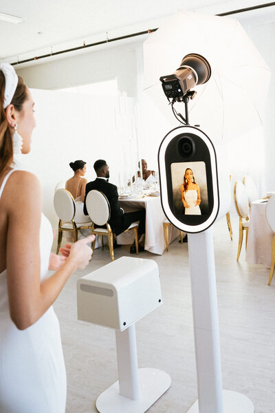 Bride using hi-resolution photo booth with printer