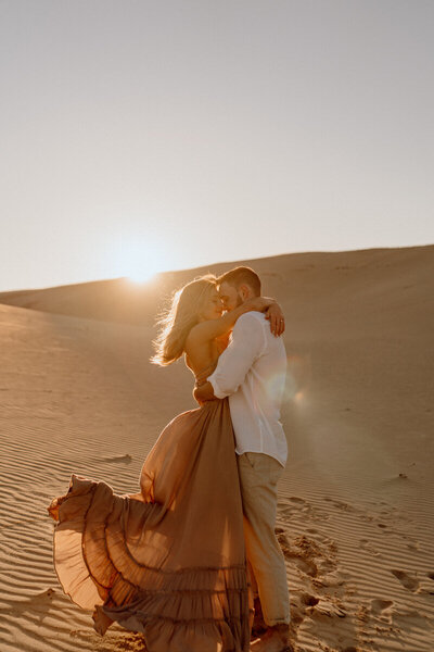 couple dancing in the sand dunes
