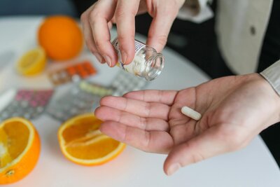 Woman taking supplements to support gut health