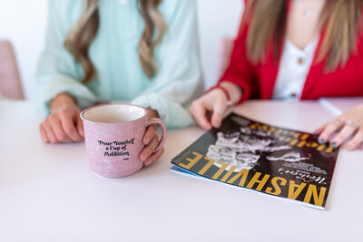 Two women with a mug and a magazine