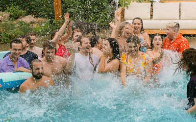 Colorado wedding photographer capturing a couple embracing outdoors with a vibrant fall bouquet