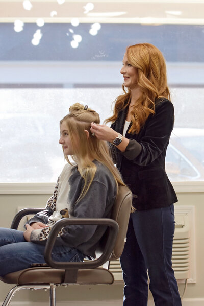 Erica chatting with a client in the styling chair