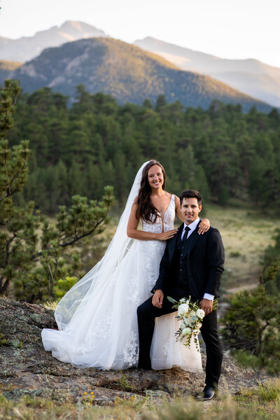 Colorado destination wedding couple poses stands proud in the mountains 