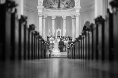 black and white catholic wedding aisle shot