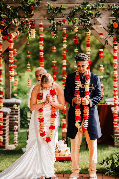 Bride and Groom facing guests and bowing heads at ceremony, Blended wedding at Peirce Farm at Witch Hill