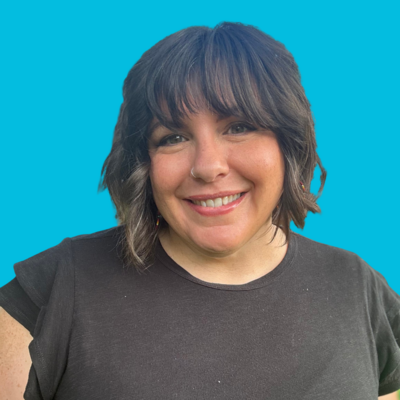 Woman Executive director at Move Forward with dark short hair in black shirt with blue background