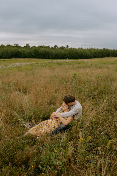 couple holding eachother in field