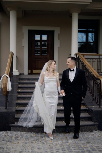 Bride and groom joyfully leaving their wedding ceremony, surrounded by guests in Columbus, Ohio.