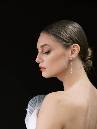Side profile of female model wearing earrings by Or & Elle Diamonds