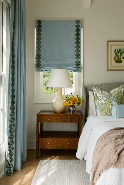Bedroom suite with green curtains and a yellow throw