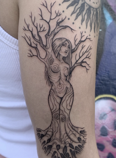 colored rose tattoo on upper arm