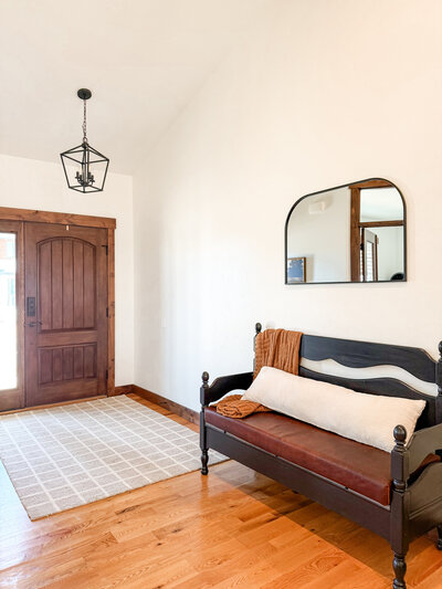 Welcoming entryway styled by KSC Interiors with wood accents and natural textures.