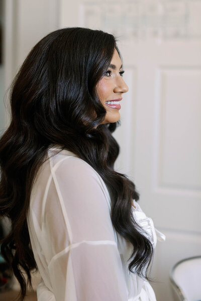 Bride in a romantic gown with long Hollywood waves — soft, luxurious hair styled by Klover Beauty for a Maryland wedding.
