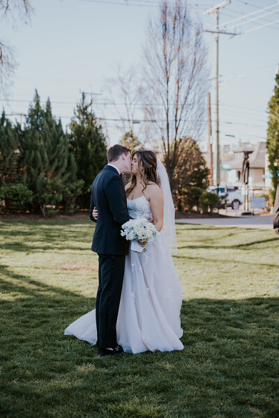 Minnesota Wedding Photographer captures bride and groom kissing outside wedding venue