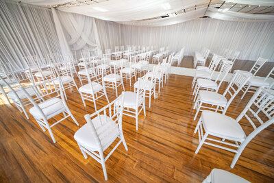 Elegant ceremony room adorned with beautiful white drapery - A captivating setting for dream ceremony and receptions