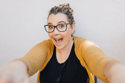 Emily Woodall Bay Area Photographer, smiles walking with camera