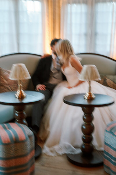 bride and groom kissing sitting down
