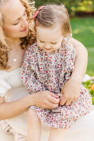 mother and daughter holding hands in a minneapolis outdoor session