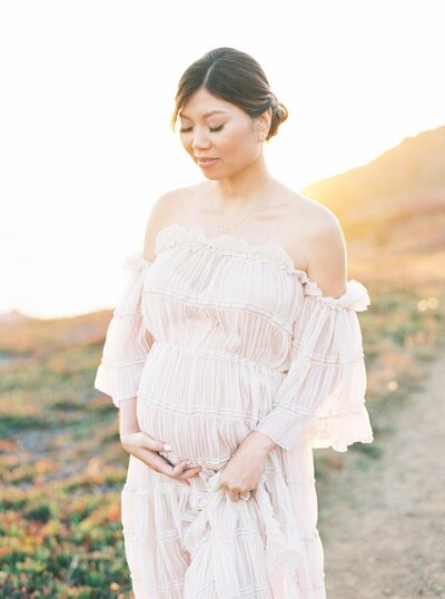 woman holding baby bump taken by maternity photographer bay area