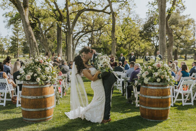 bride and groom posing outside