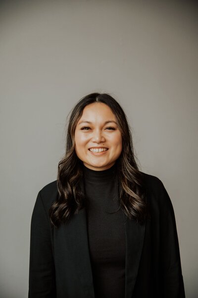 Jamie Cruz smiling in black sweater