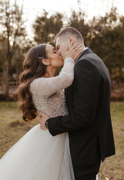 Kathleen and Mirza kissing at their wedding at The Tides Estate