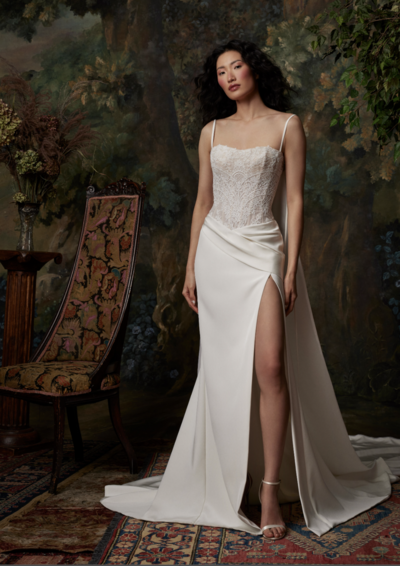 Lingerie strap corset with basque waist and hand draped skirt with slit. Low illusion back with ties