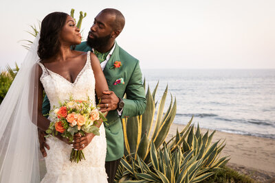 Couple by the sea embracing.