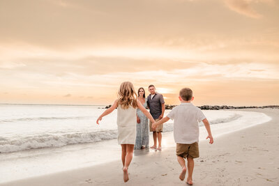 children run to parents during fun family photo shoot in St. Pete Beach