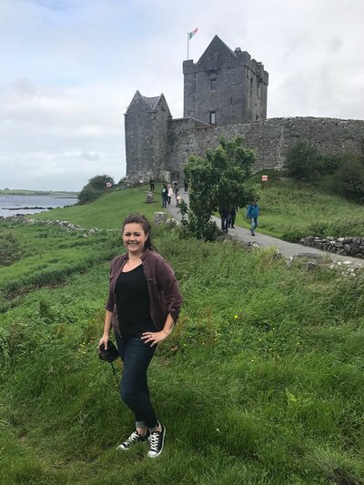 Hiliary photographed in front of a castle in Ireland