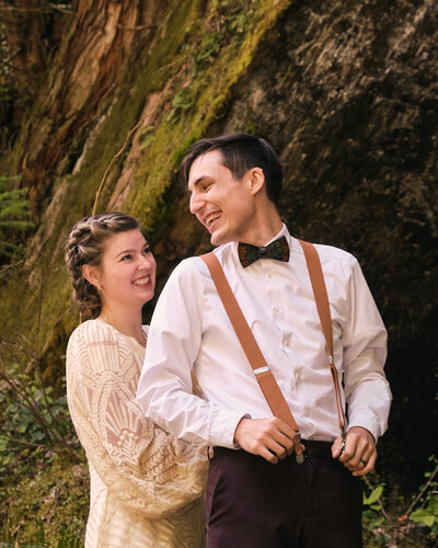 A bride helps her groom get ready for their Mt. Rainier elopement