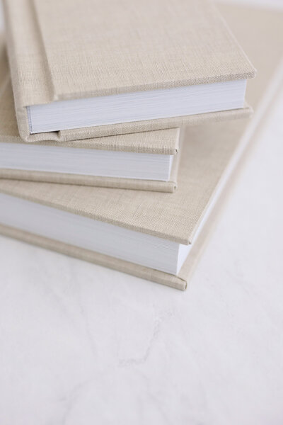 Close-up of a baby's face and hand resting on a soft white fabric. The focus is on the babys lips and tiny fingers, conveying a peaceful and gentle mood. The soft fabric adds to the cozy and serene atmosphere.