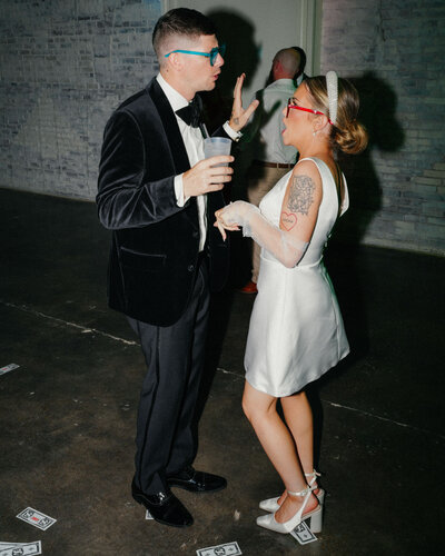 bride and groom share a fun moment on a dance floor.