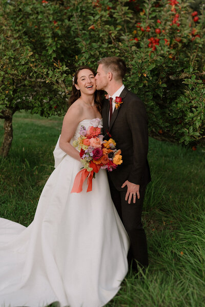 Two brides laughing at speeches