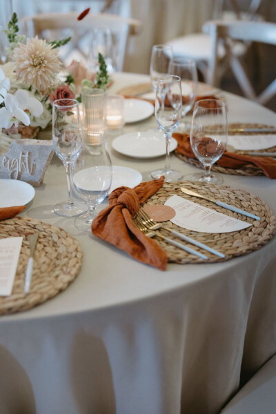 Captivating wedding reception florals with pastel blooms and natural greenery by Leigh Florist, elevating the ambiance of the venue.