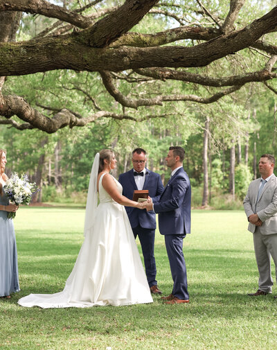 Couple holding hands as the bride looks back at the camera during an Engagement Session