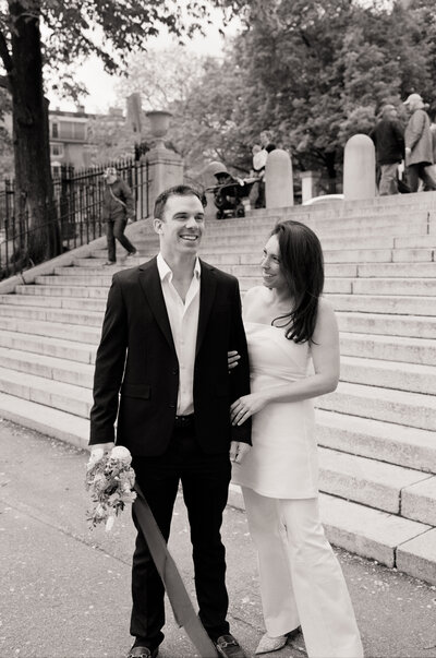 couple in boston public garden holding hands for elopement portraits on black and white medium format film 