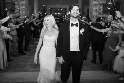 Black and white photo of bride and groom doing a sparkler exit